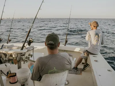 Drift boat below Holter Dam with mountains behind